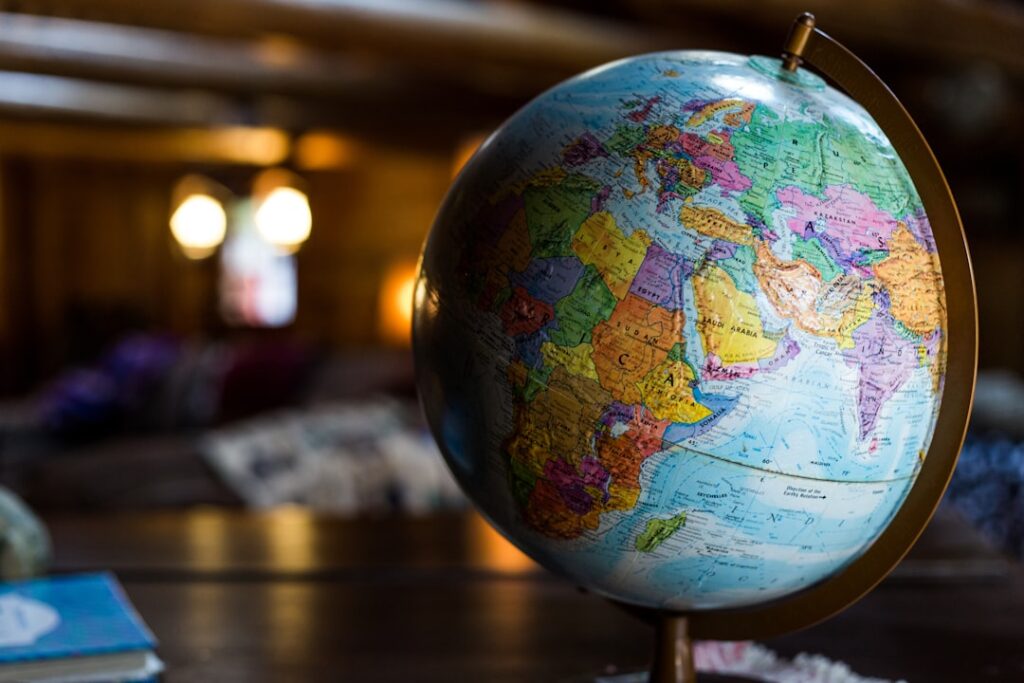 Close-up of a colorful globe showing continents and countries, symbolizing global travel and international experiences.