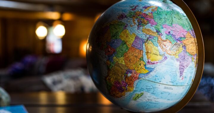 Close-up of a colorful globe showing continents and countries, symbolizing global travel and international experiences.